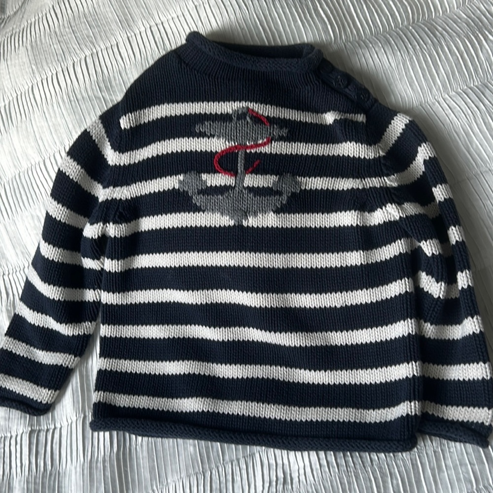 Knit sweater with button detail on the left shoulder